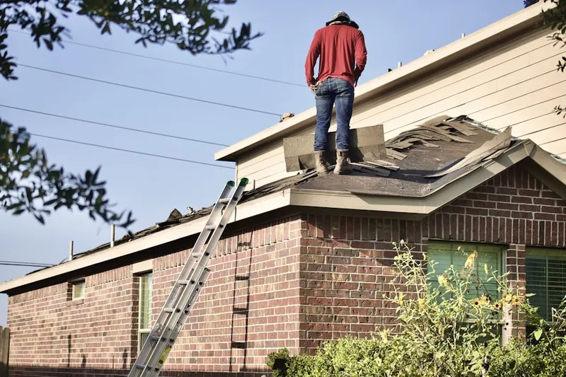 Professional roofer working on a residential roof in Circle J